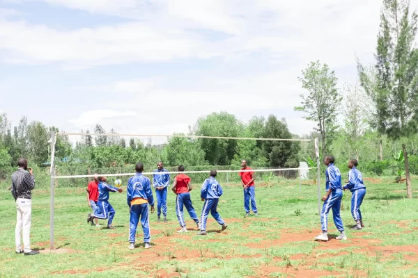 PCEA Enoomatasiani Booth Boys High School - students playing volleyball at the pitch