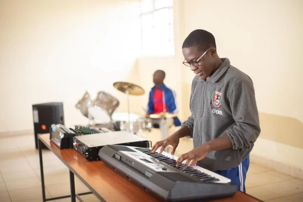 PCEA Enoomatasiani Booth Boys High School - students playing keyboard and drums