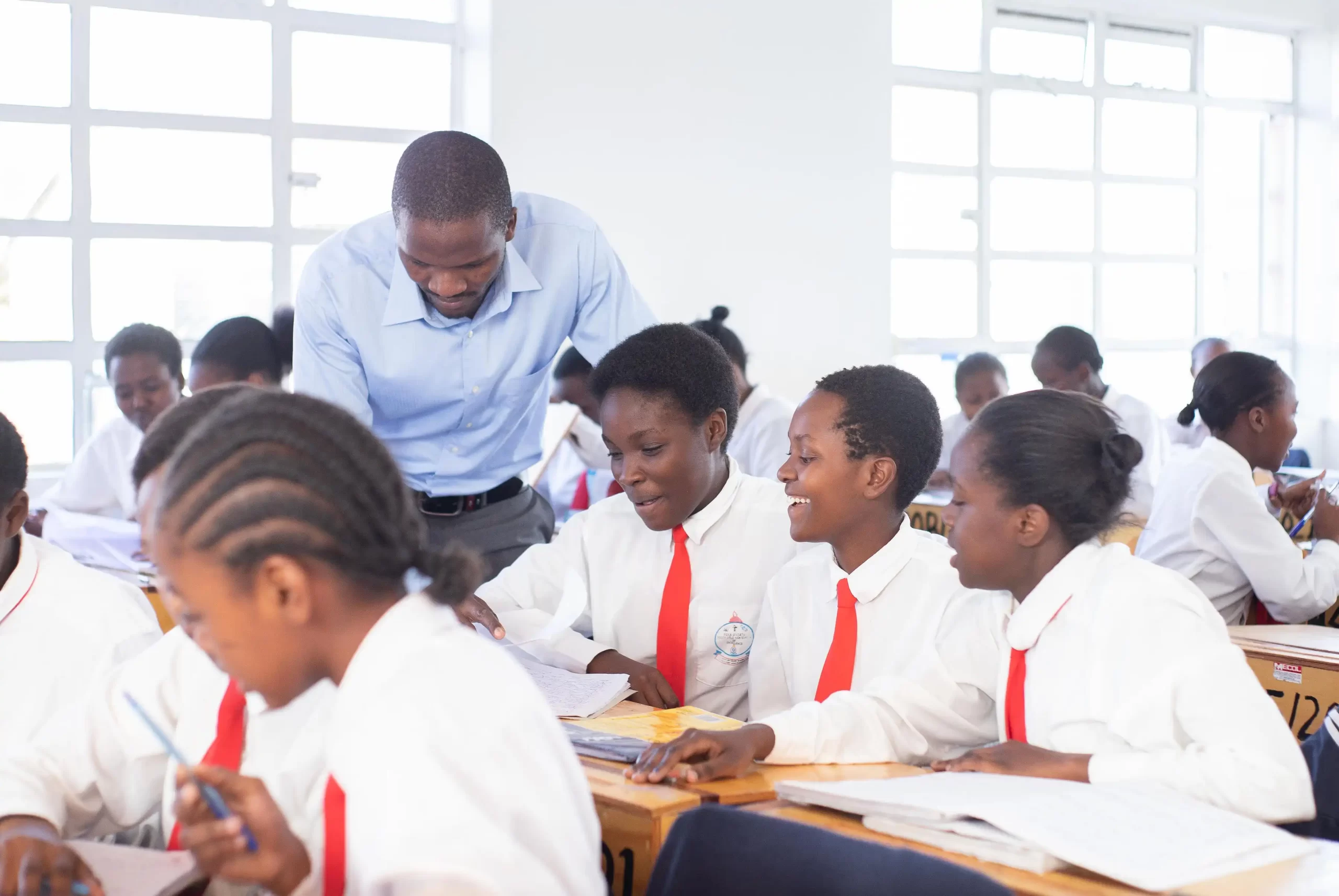 PCEA Ongata Booth Girls High School - students having small group discussions with teacher going round