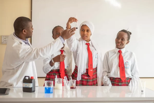 PCEA Ongata Booth Girls High School - students studying in the lab with their teacher