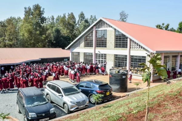 PCEA Kanjeru Booth Girls High School students outside the administration block