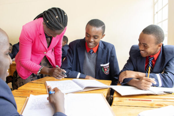 PCEA Enoomatasiani Booth Boys High School students all smiles studying in small groups as the teacher goes round,